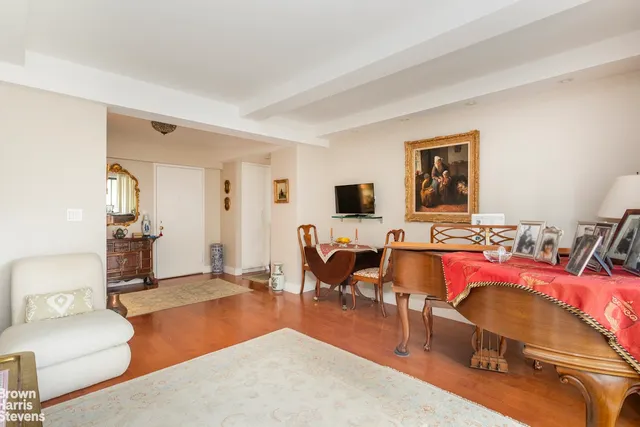 a living room with furniture a air conditioner vent and a window