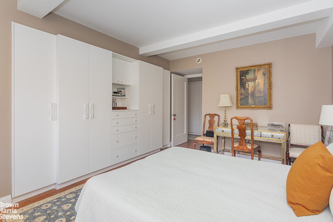 750 Park Avenue, Unit 12B Manhattan, NY 10021 - Photo 5 of 10 a bedroom with a bed and furniture