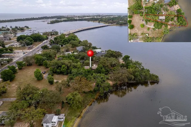 an aerial view of house with yard and lake view