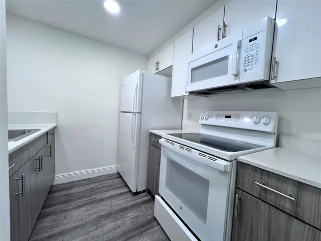 a kitchen with stainless steel appliances a stove a microwave and a refrigerator