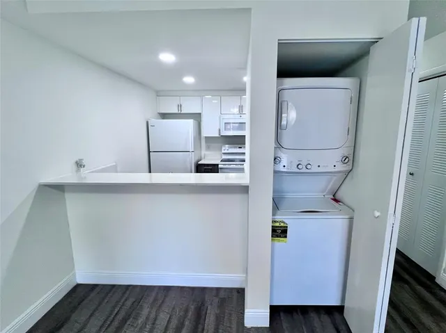 a kitchen with a refrigerator and cabinets