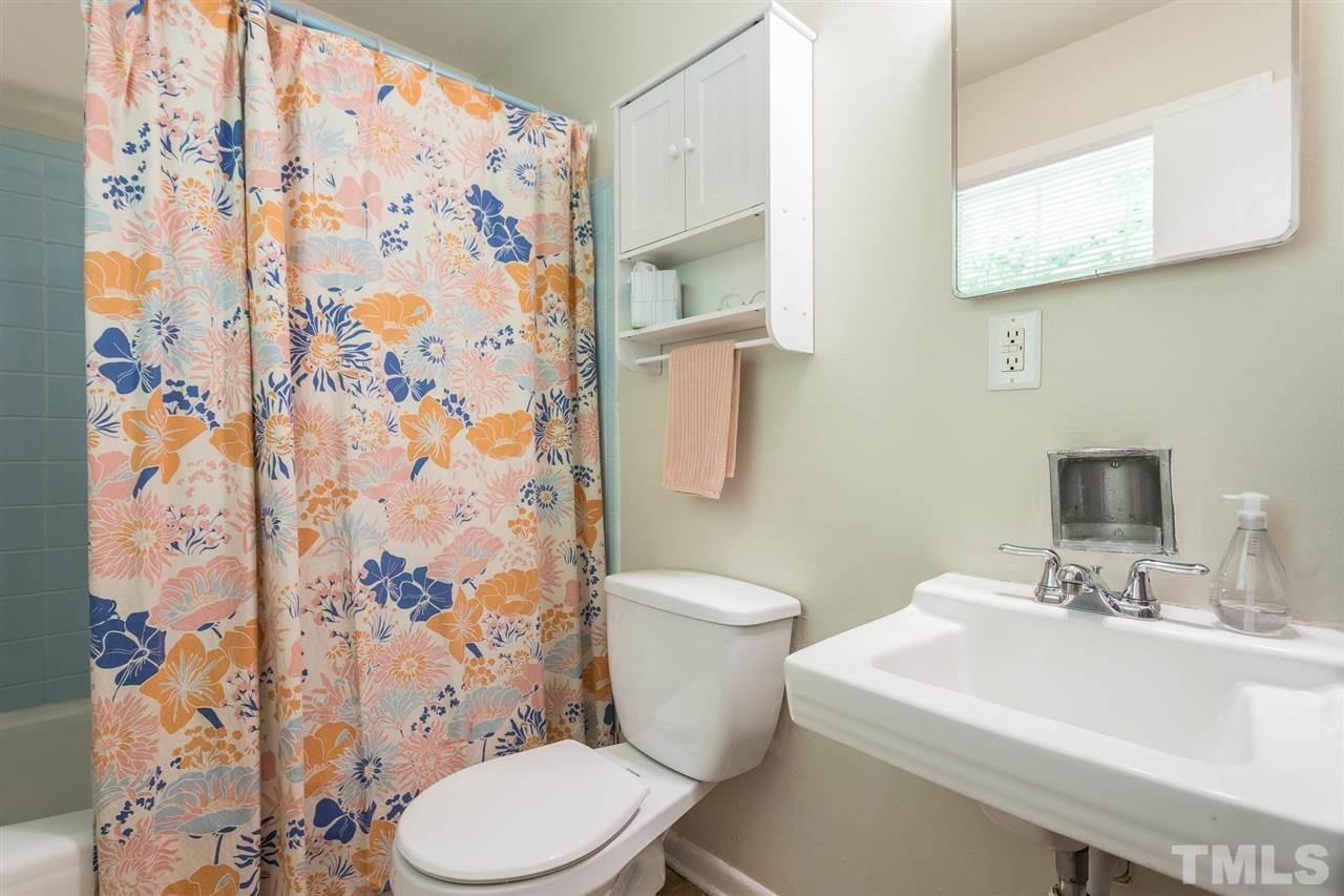 812 Cooper Road Raleigh, NC 27610 - Photo 22 of 29 Master bath is mostly original, featuring 1960s blue tile in the shower surround