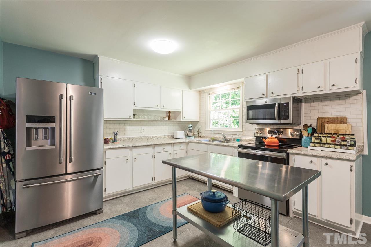 812 Cooper Road Raleigh, NC 27610 - Photo 8 of 29 Large kitchen has stainless appliances and a stainless island