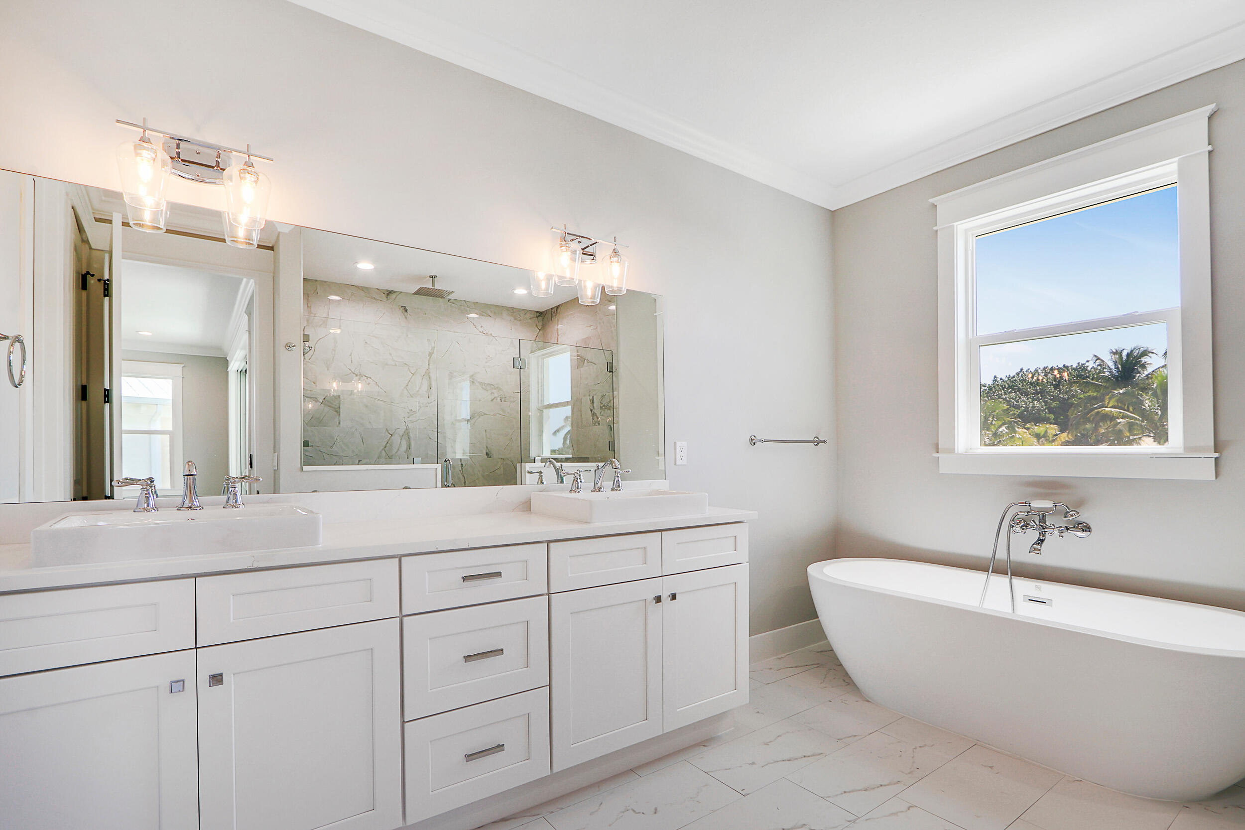 4629 Southeast Manatee Lane Stuart, FL 34997 - Photo 12 of 31 a bathroom with a tub a sink double vanity and a mirror