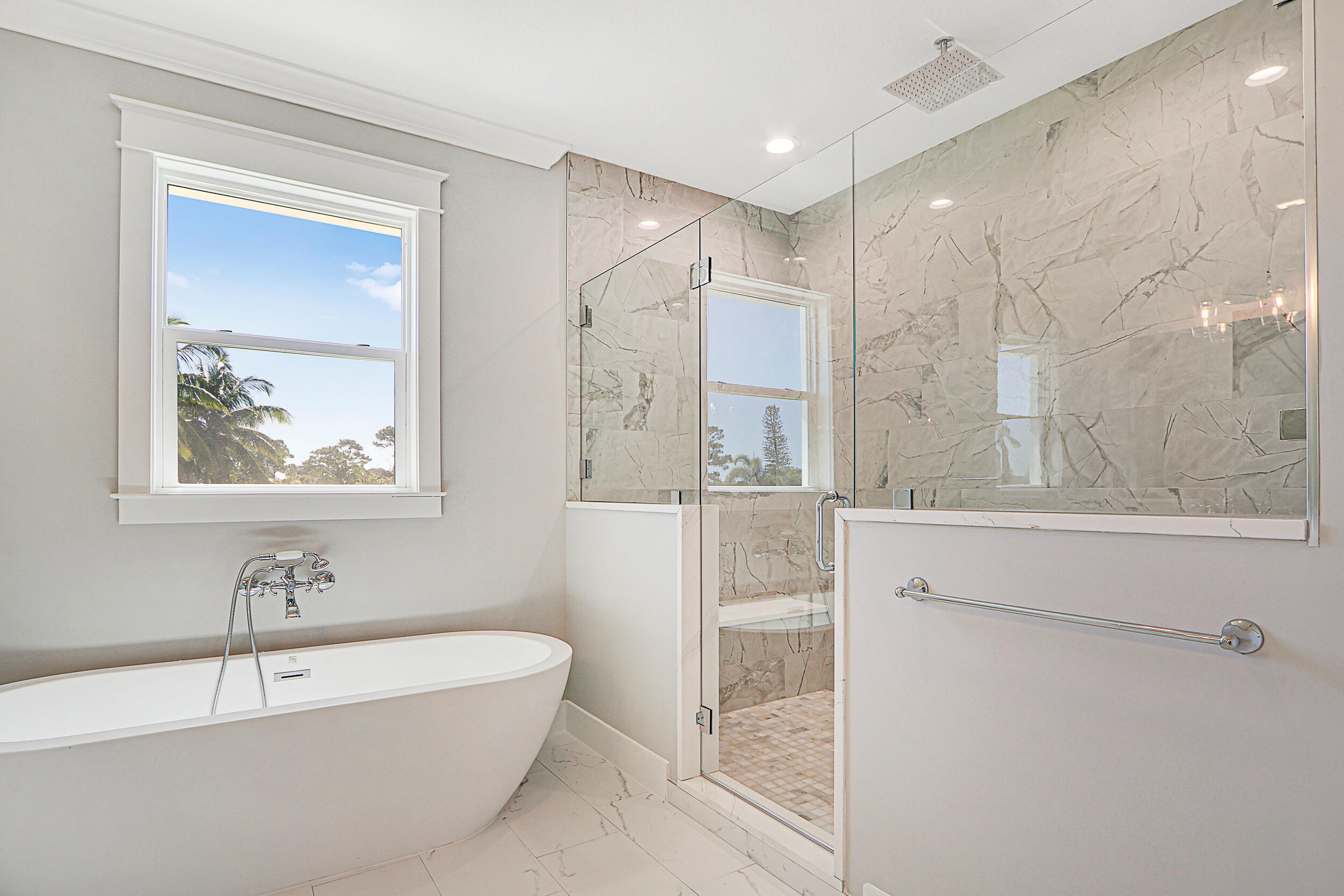 4629 Southeast Manatee Lane Stuart, FL 34997 - Photo 13 of 31 a bathroom with a bathtub and a shower