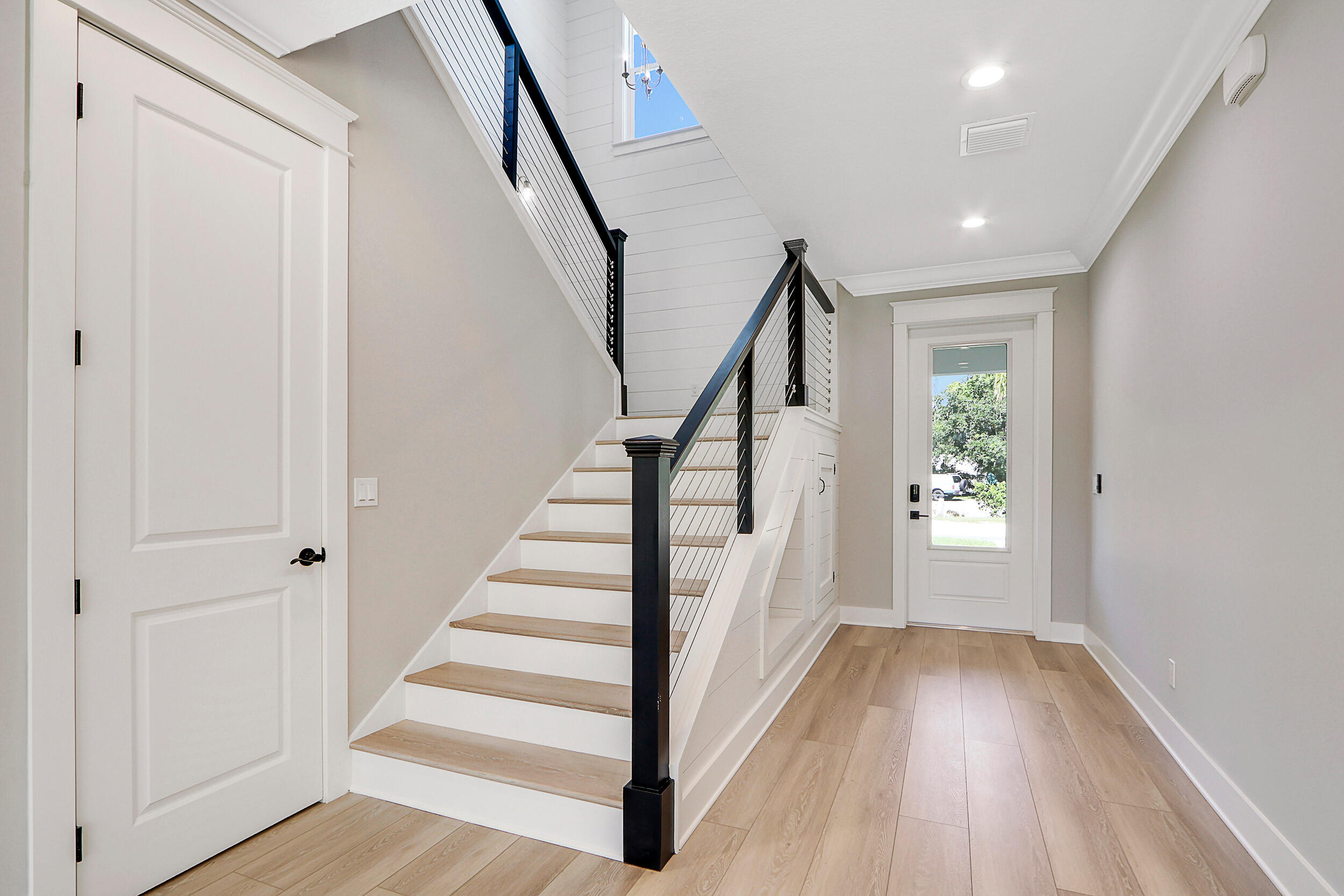 4629 Southeast Manatee Lane Stuart, FL 34997 - Photo 10 of 31 a view of entryway with wooden floor and stairs