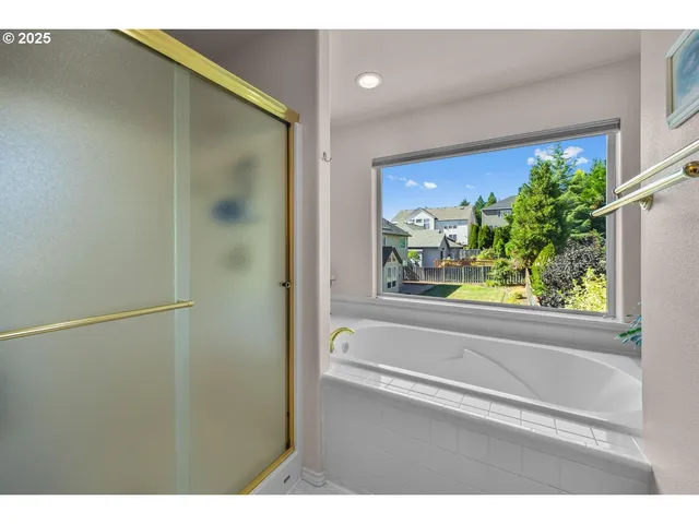 a bathroom with a bathtub and a shower