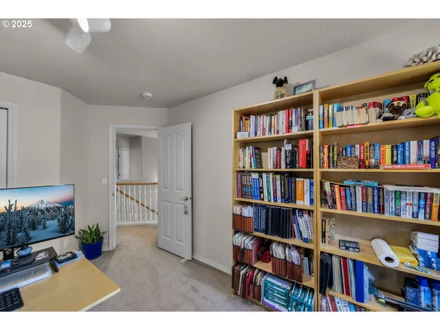 a living room with furniture and a book shelf