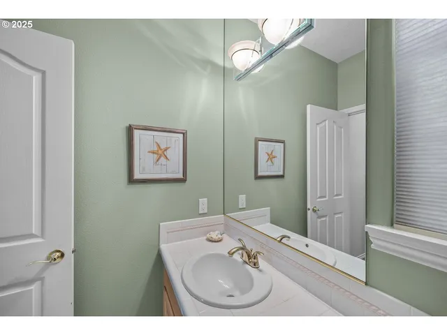 a bathroom with a sink mirror and vanity