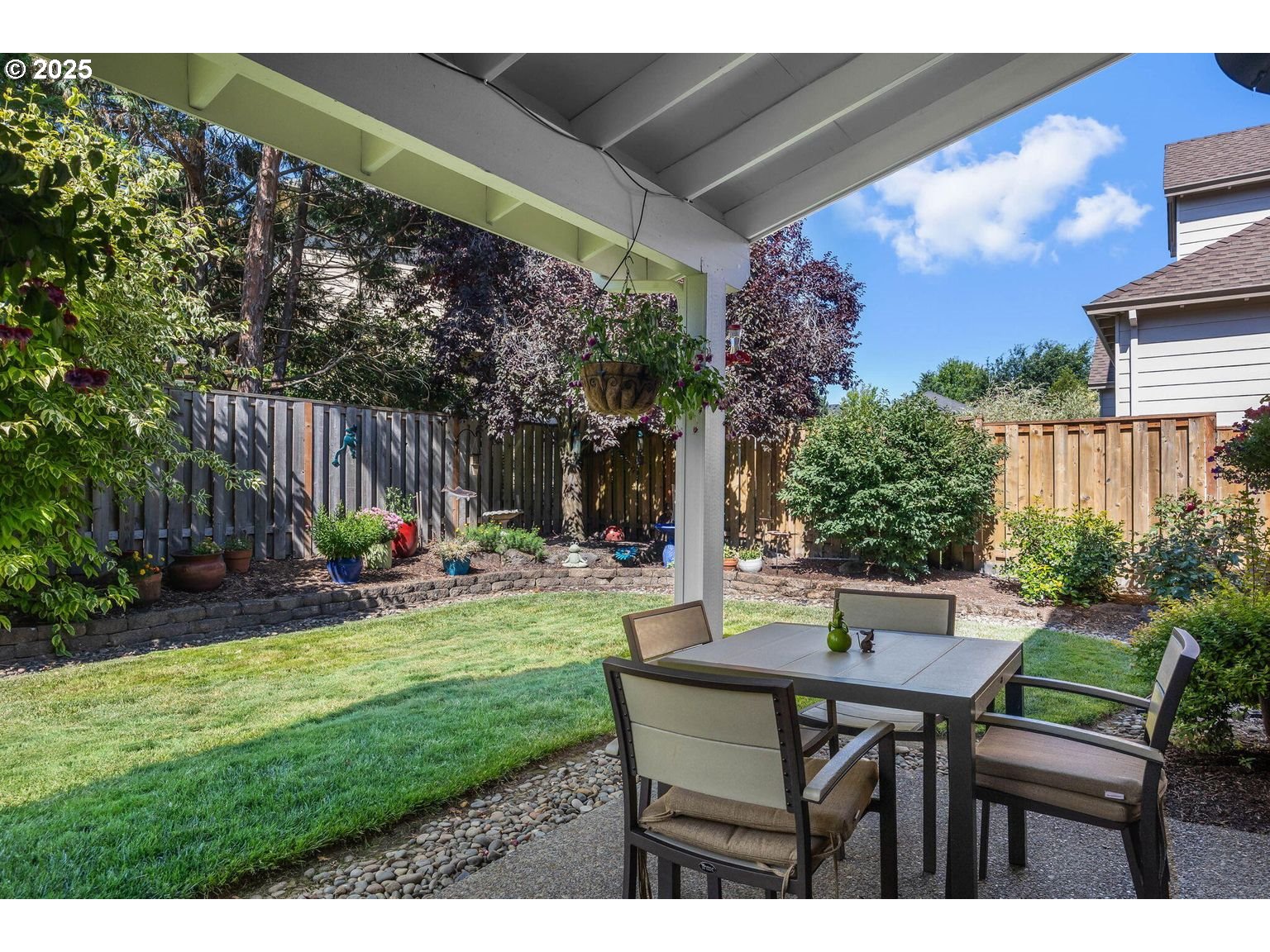 14941 Northwest Wendy Lane Portland, OR 97229 - Photo 26 of 26 a view of a backyard with table and chairs potted plants and a palm tree