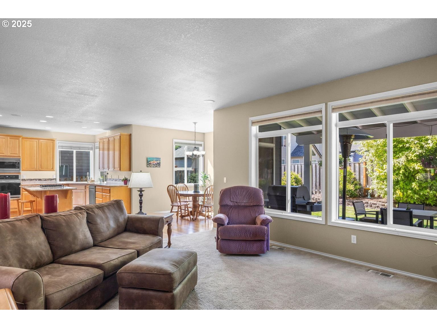 14941 Northwest Wendy Lane Portland, OR 97229 - Photo 5 of 26 a living room with furniture and a floor to ceiling window