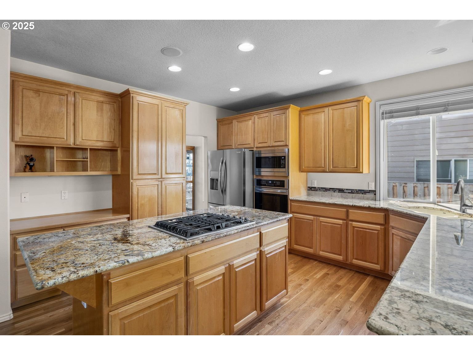 14941 Northwest Wendy Lane Portland, OR 97229 - Photo 7 of 26 a kitchen with stainless steel appliances granite countertop a refrigerator and a stove top oven