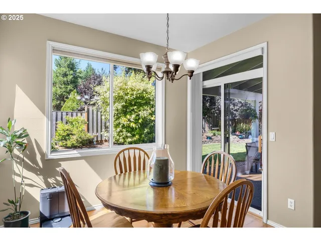a dining room with furniture a chandelier and window