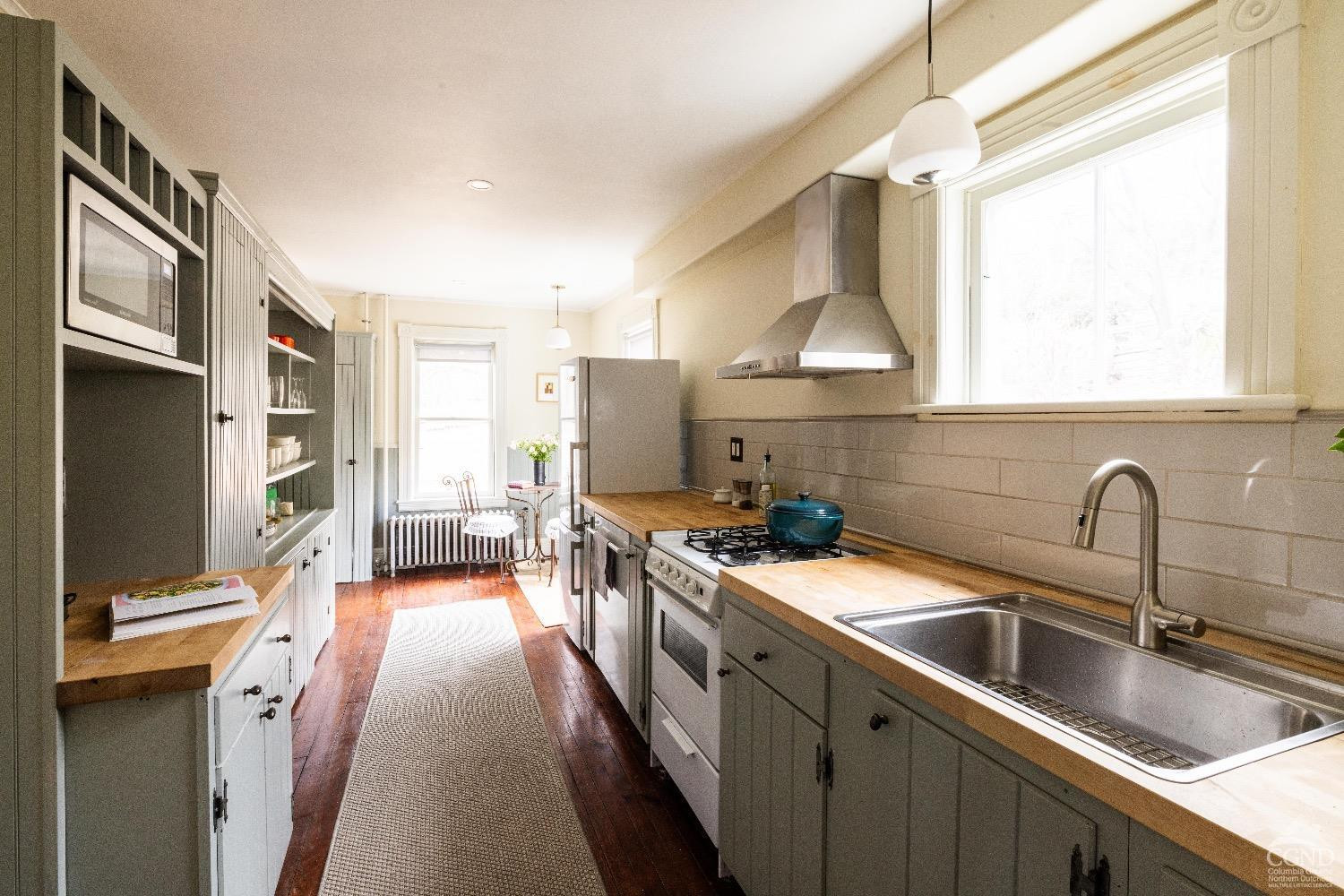 1301 Co Rte 7 Ancram, NY 12502 - Photo 16 of 52 a kitchen with stainless steel appliances a sink stove and cabinets