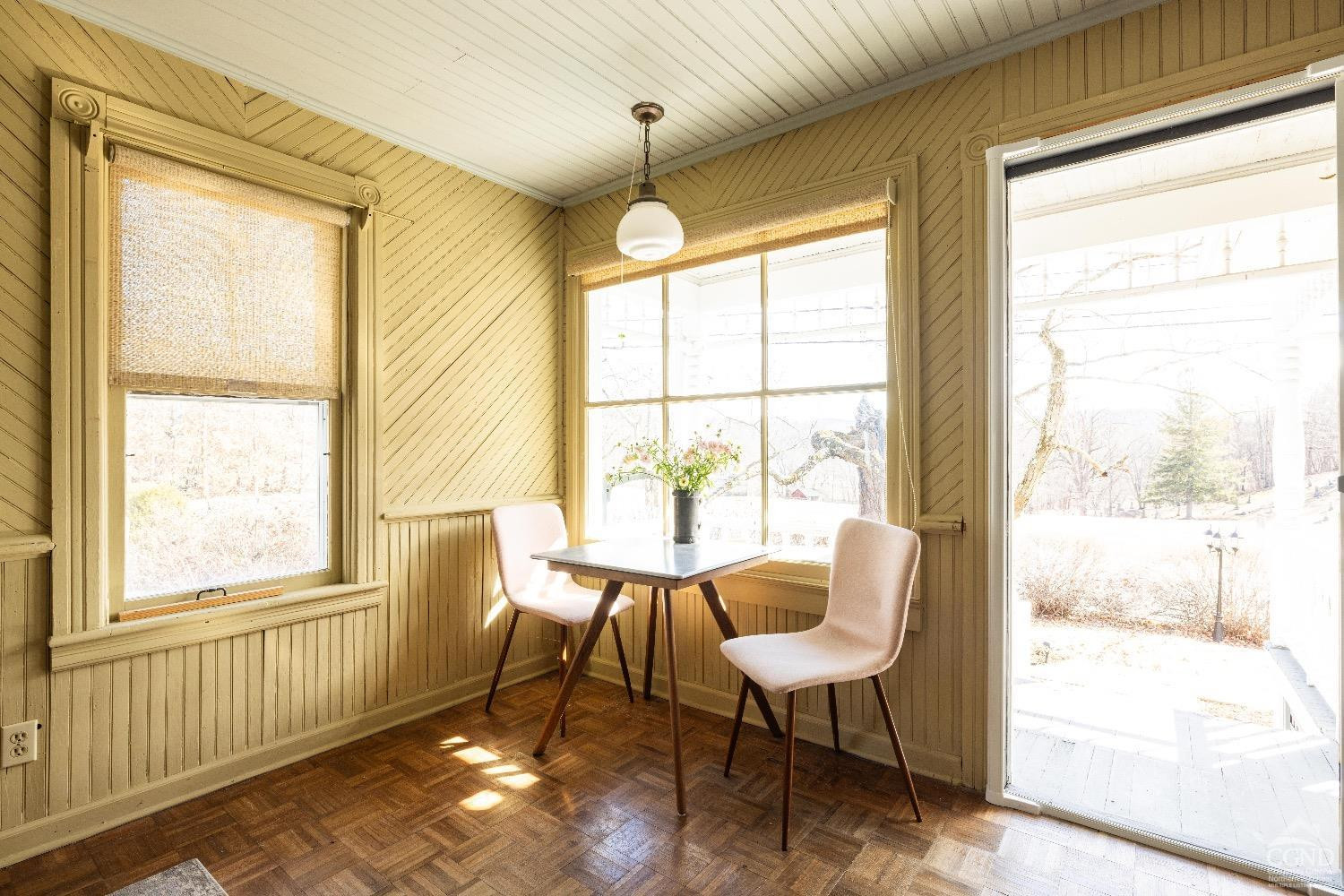 1301 Co Rte 7 Ancram, NY 12502 - Photo 32 of 52 a view of a dining room with furniture a chandelier and wooden floor