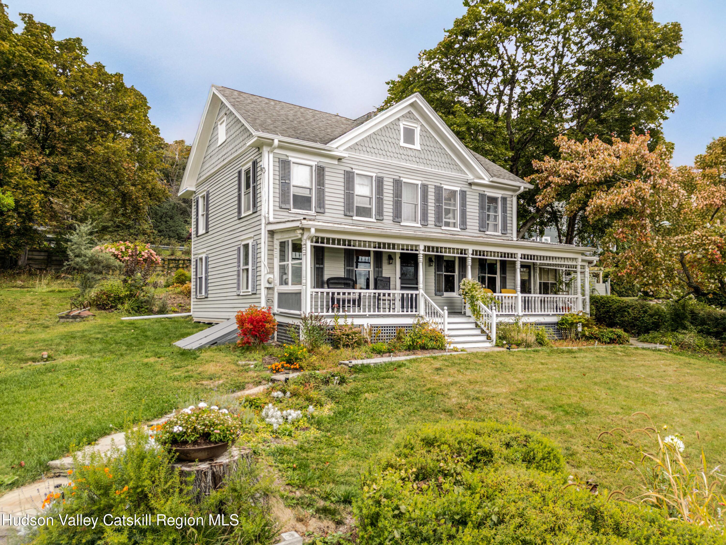1301 Co Rte 7 Ancram, NY 12502 - Photo 44 of 52 a front view of a house with a yard table and chairs