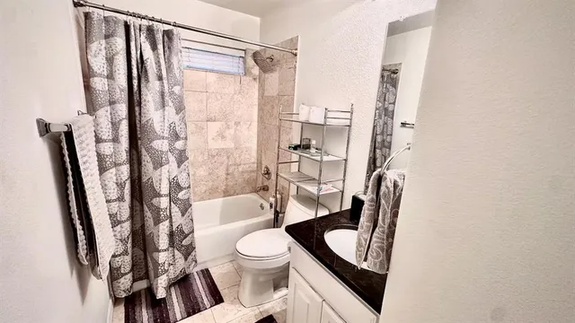 a bathroom with a toilet a sink and a shower