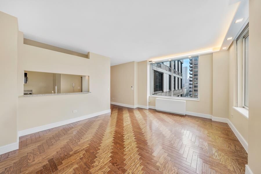 200 Riverside Boulevard, Unit 15E Manhattan, NY 10069 - Photo 3 of 15 a view of an empty room with a window