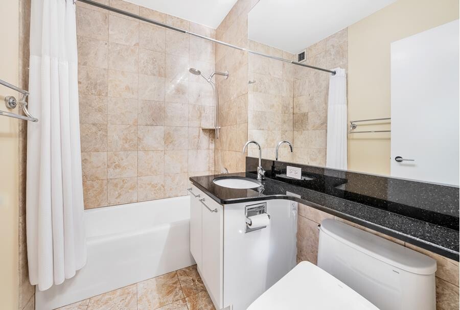 200 Riverside Boulevard, Unit 15E Manhattan, NY 10069 - Photo 8 of 15 a bath room with a sink and a bath tub