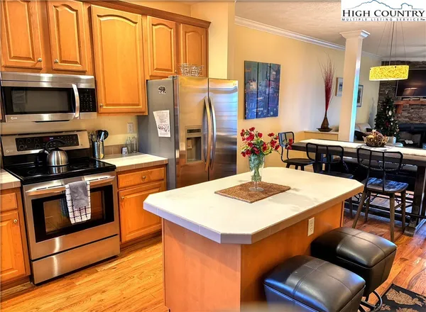 a kitchen with a sink a stove and chairs