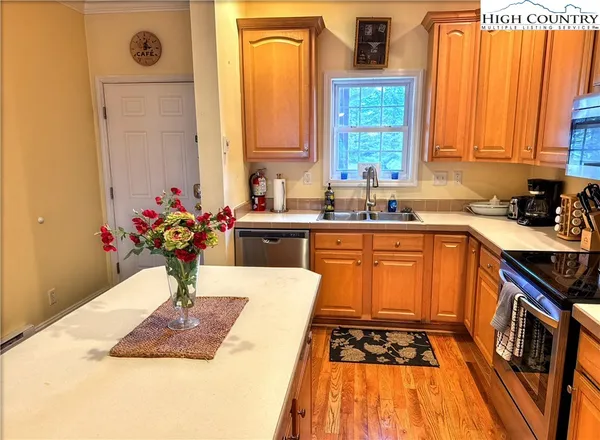 a kitchen with a sink stove and cabinets
