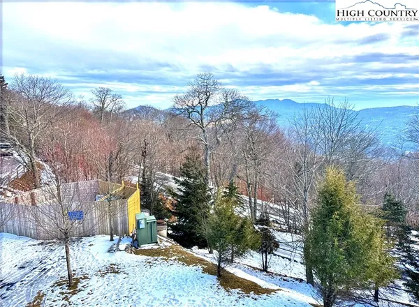 a view of a yard with mountains in the background
