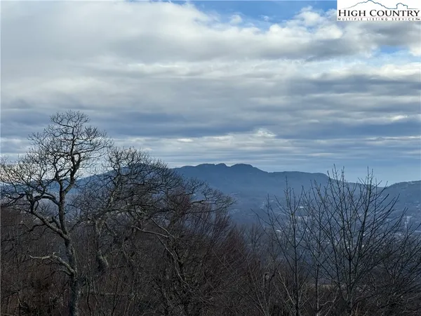 a balcony with table and chairs