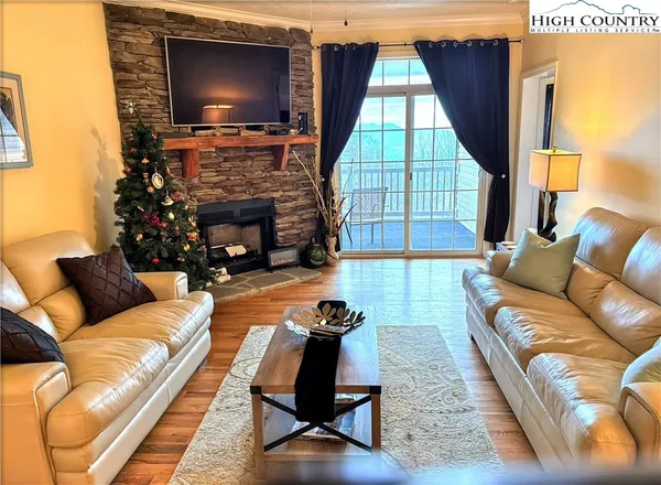 a living room with fireplace furniture and a flat screen tv