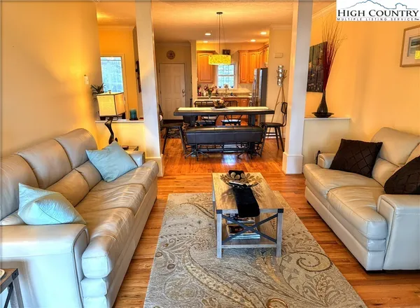 a living room with furniture rug and a table
