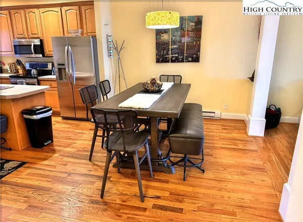 a dining room with furniture and wooden floor