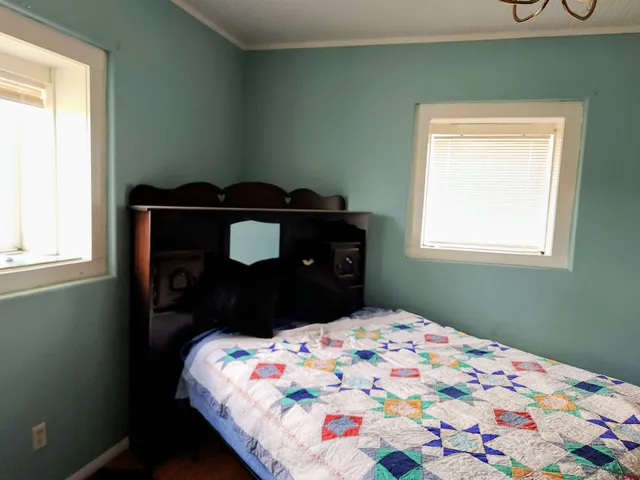 a bedroom with a bed and window