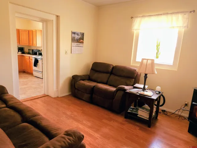 a bedroom with furniture and a wooden floor