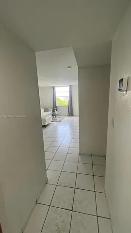 a view of a livingroom with wooden floor and a cabinet