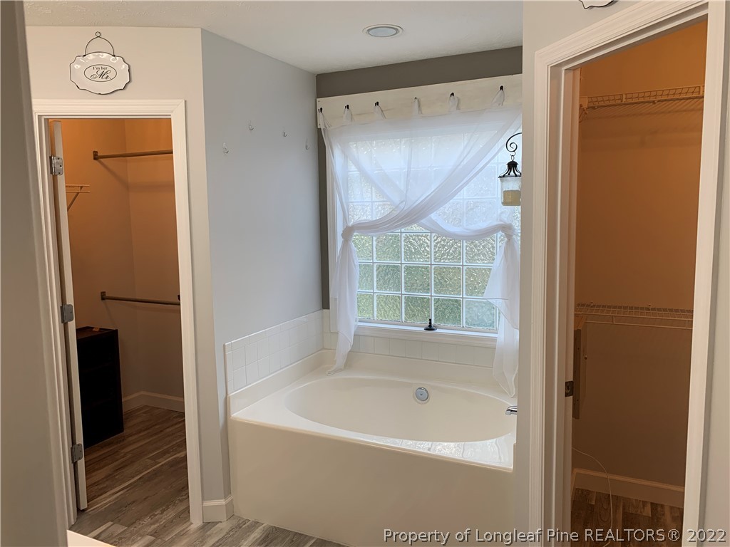 5428 Arnette Road Hope Mills, NC 28348 - Photo 19 of 41 a bathroom with a bathtub and a shower