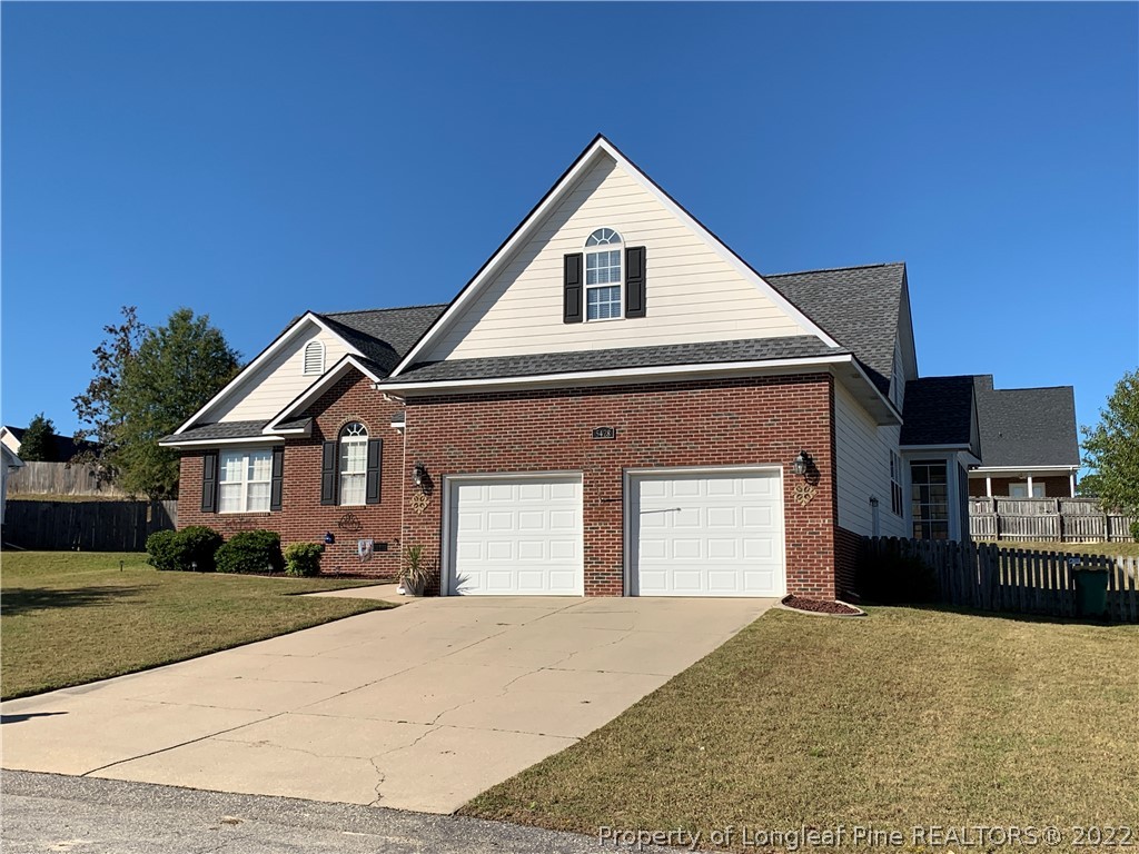 5428 Arnette Road Hope Mills, NC 28348 - Photo 2 of 41 a front view of a house with a yard and garage