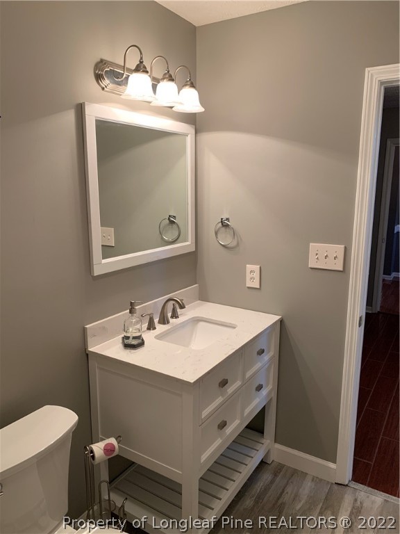 5428 Arnette Road Hope Mills, NC 28348 - Photo 21 of 41 a bathroom with a toilet sink and mirror