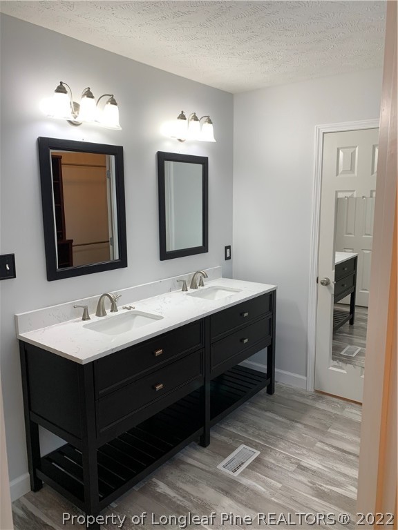5428 Arnette Road Hope Mills, NC 28348 - Photo 22 of 41 a bathroom with a double vanity sink and a mirror