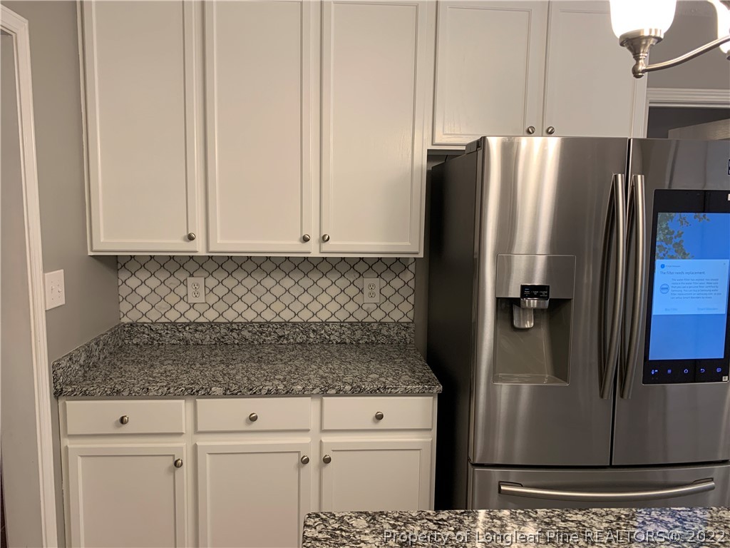 5428 Arnette Road Hope Mills, NC 28348 - Photo 27 of 41 a kitchen with stainless steel appliances granite countertop a refrigerator and a stove