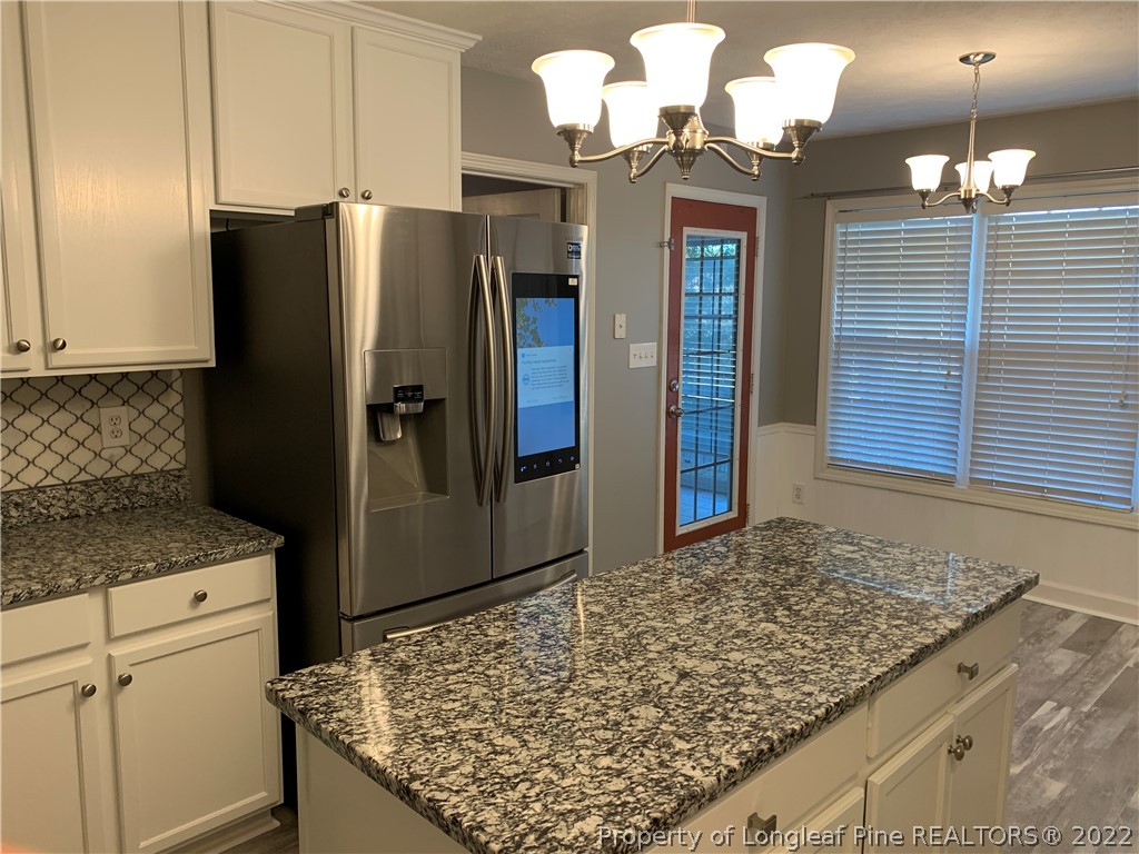 5428 Arnette Road Hope Mills, NC 28348 - Photo 28 of 41 a kitchen with stainless steel appliances granite countertop a refrigerator a oven and a sink