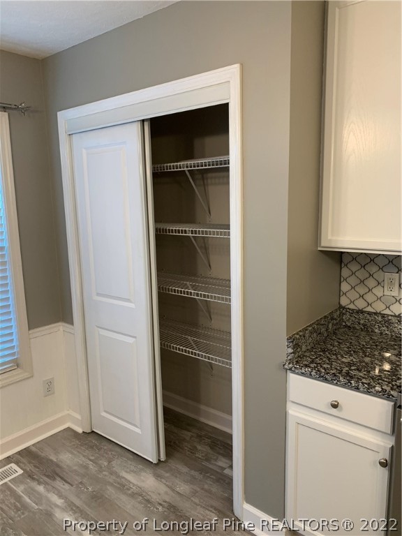 5428 Arnette Road Hope Mills, NC 28348 - Photo 32 of 41 a view of walk in closet with wooden floor