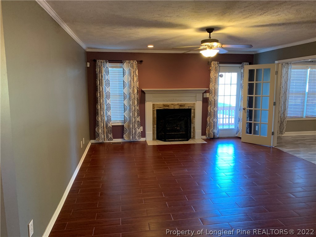 5428 Arnette Road Hope Mills, NC 28348 - Photo 10 of 41 an empty room with wooden floor fireplace and windows