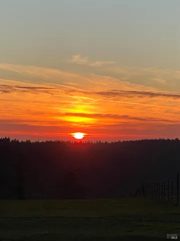 an aerial view of mountains residential house and green space