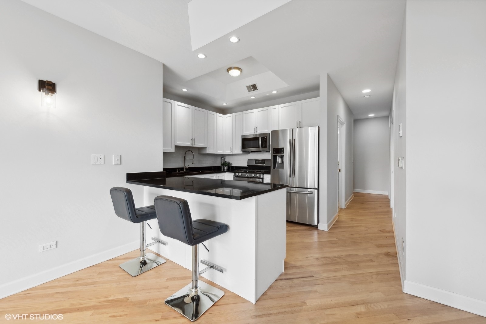 820 West Hubbard Street, Unit 4 Chicago, IL 60642 - Photo 11 of 28 a kitchen with granite countertop a refrigerator and a stove top oven