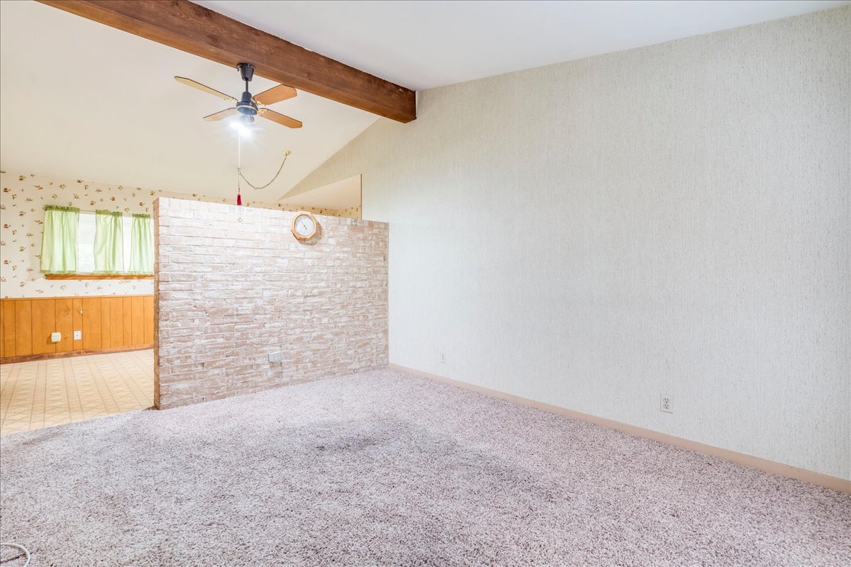 6626 Isabelle Drive Austin, TX 78752 - Photo 7 of 27 Vaulted ceilings featuring a wood beam and ceiling fan