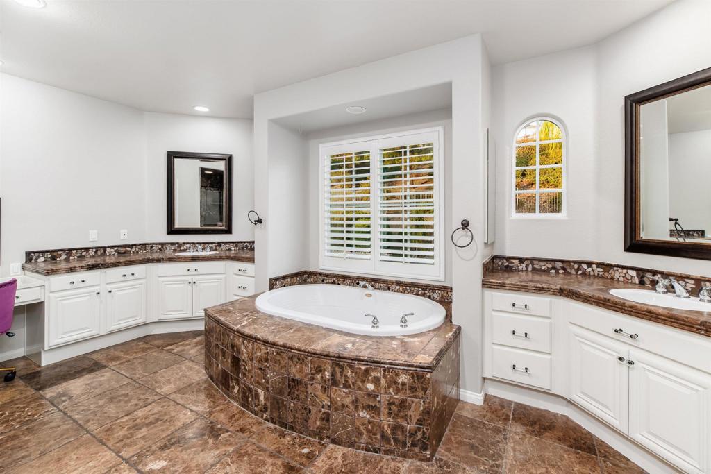 1459 Lighthouse Road San Marcos, CA 92078 - Photo 24 of 50 a spacious bathroom with a tub sink and mirror