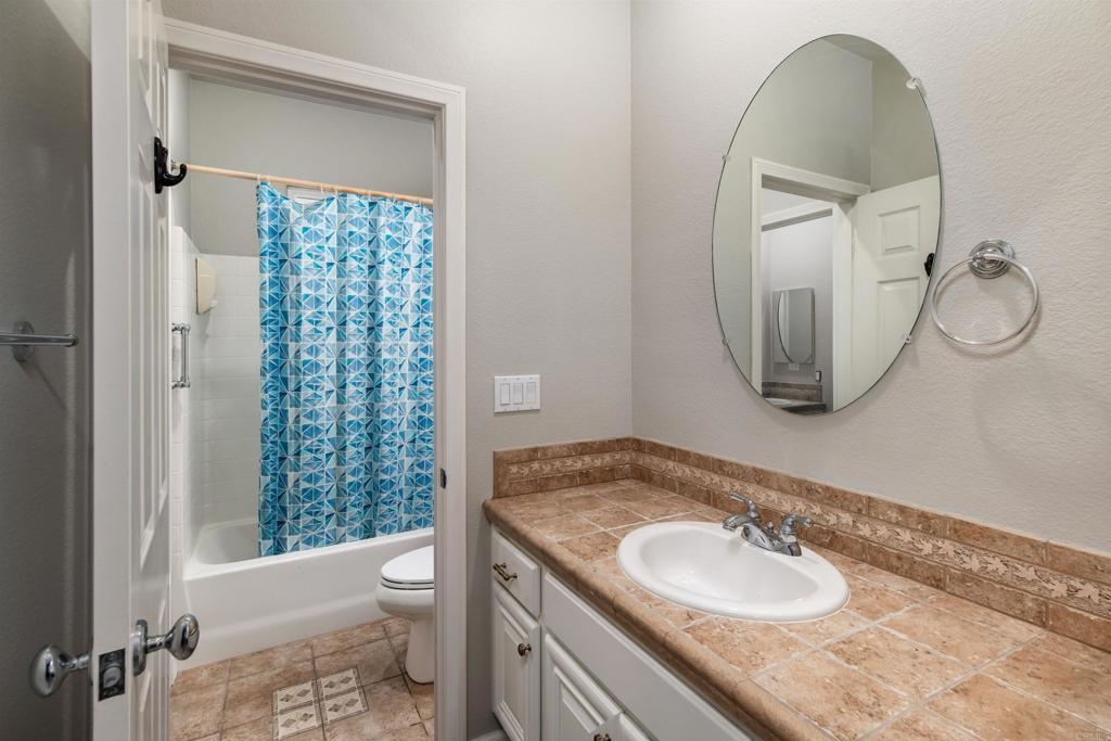 1459 Lighthouse Road San Marcos, CA 92078 - Photo 28 of 50 a bathroom with a granite countertop sink toilet and shower