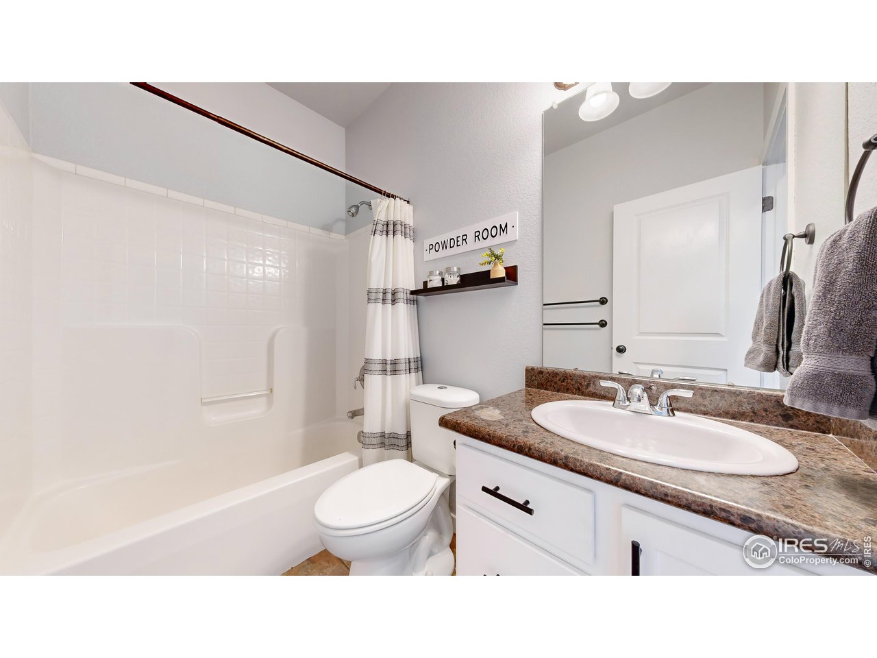 511 Wind River Drive Windsor, CO 80550 - Photo 11 of 22 a bathroom with a sink a toilet a mirror and shower