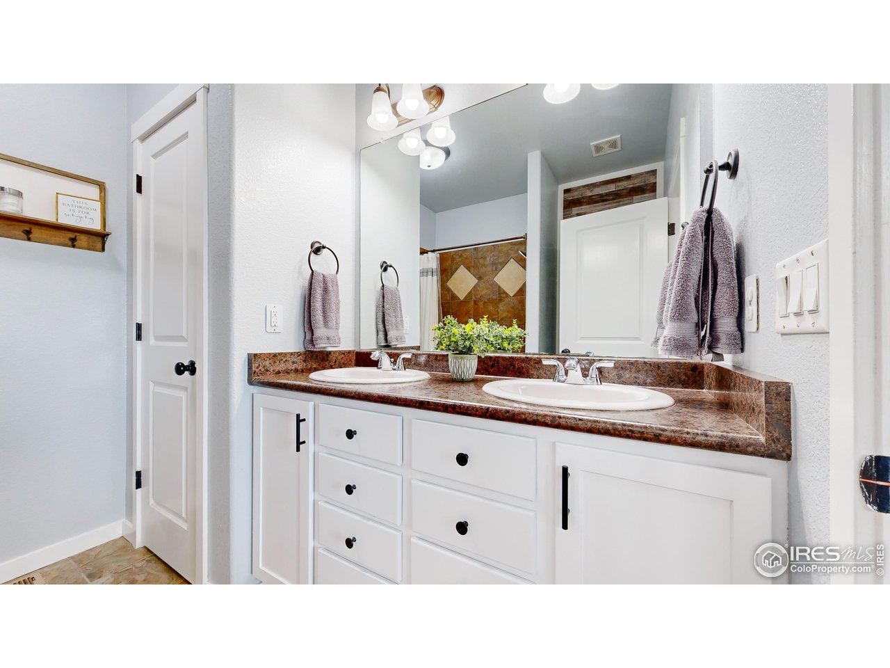 511 Wind River Drive Windsor, CO 80550 - Photo 15 of 22 a bathroom with a sink double vanity and a mirror