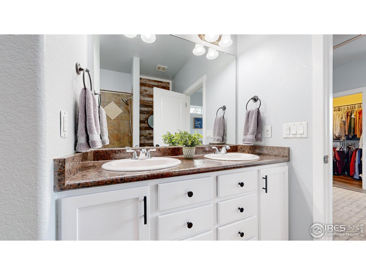 511 Wind River Drive Windsor, CO 80550 - Photo 16 of 22 a bathroom with a sink double vanity granite and a mirror