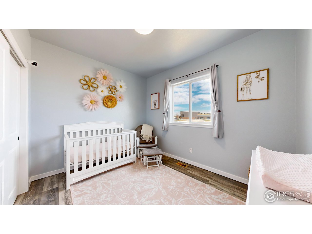 511 Wind River Drive Windsor, CO 80550 - Photo 9 of 22 a bedroom with a bed and painting on the wall